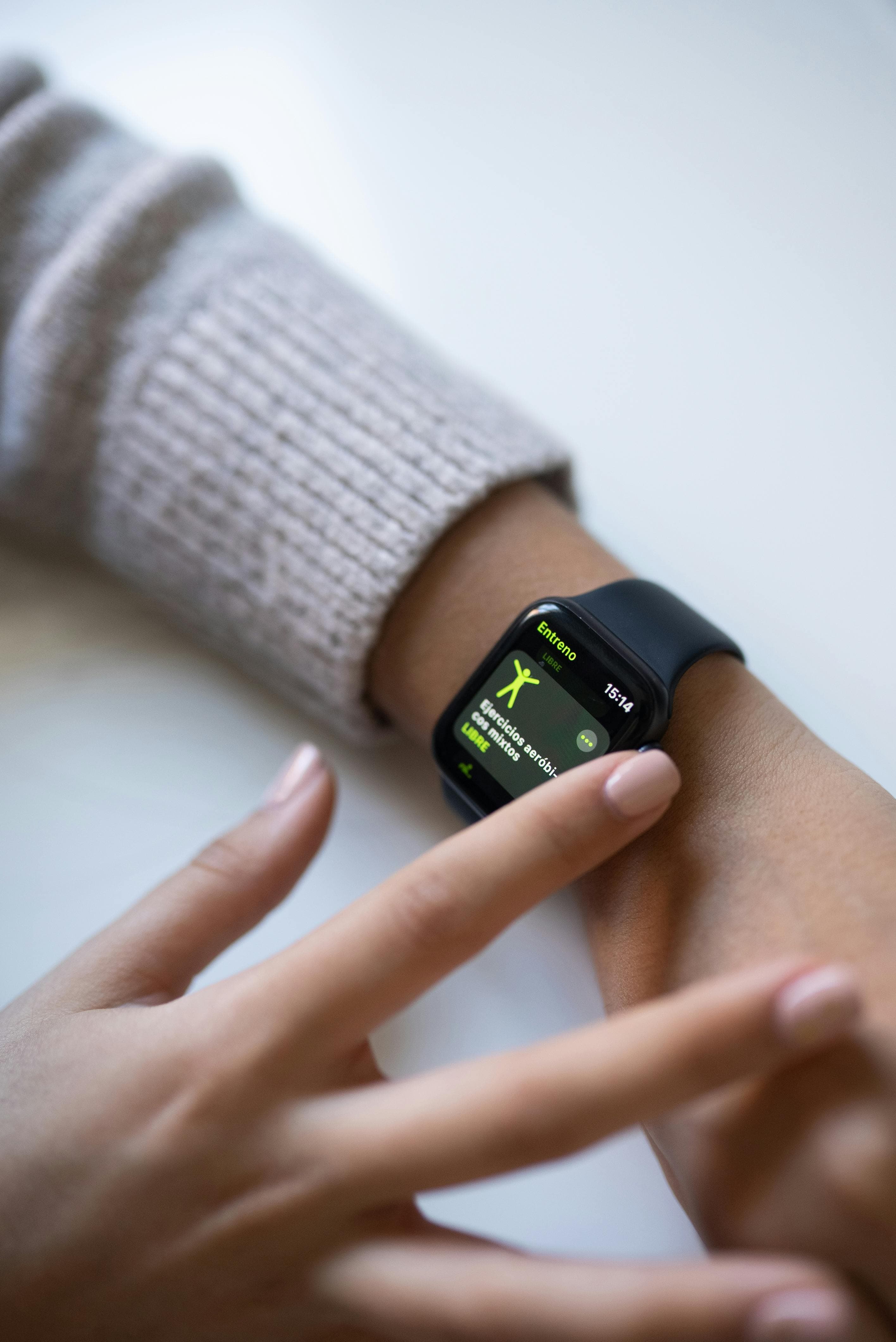Close-up of a smartwatch showing fitness tracking data on an athlete's wrist